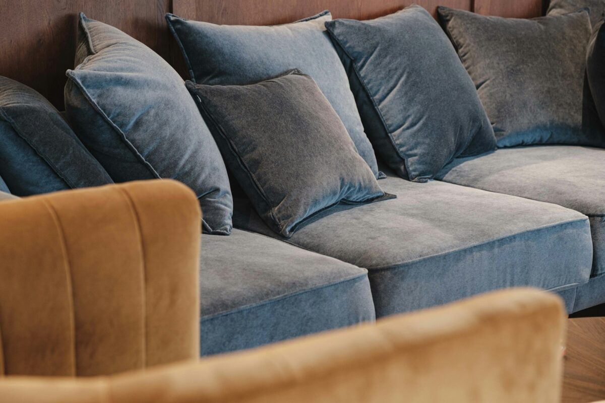 Velour-sofa med puder i jordtoner