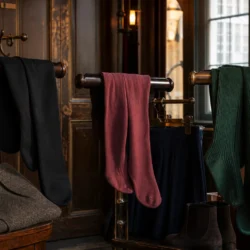 Sorte, rosa og mørkegrønne strømpebukser i en garderobe