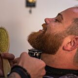 Mand der får trimmet skæg i barbershop