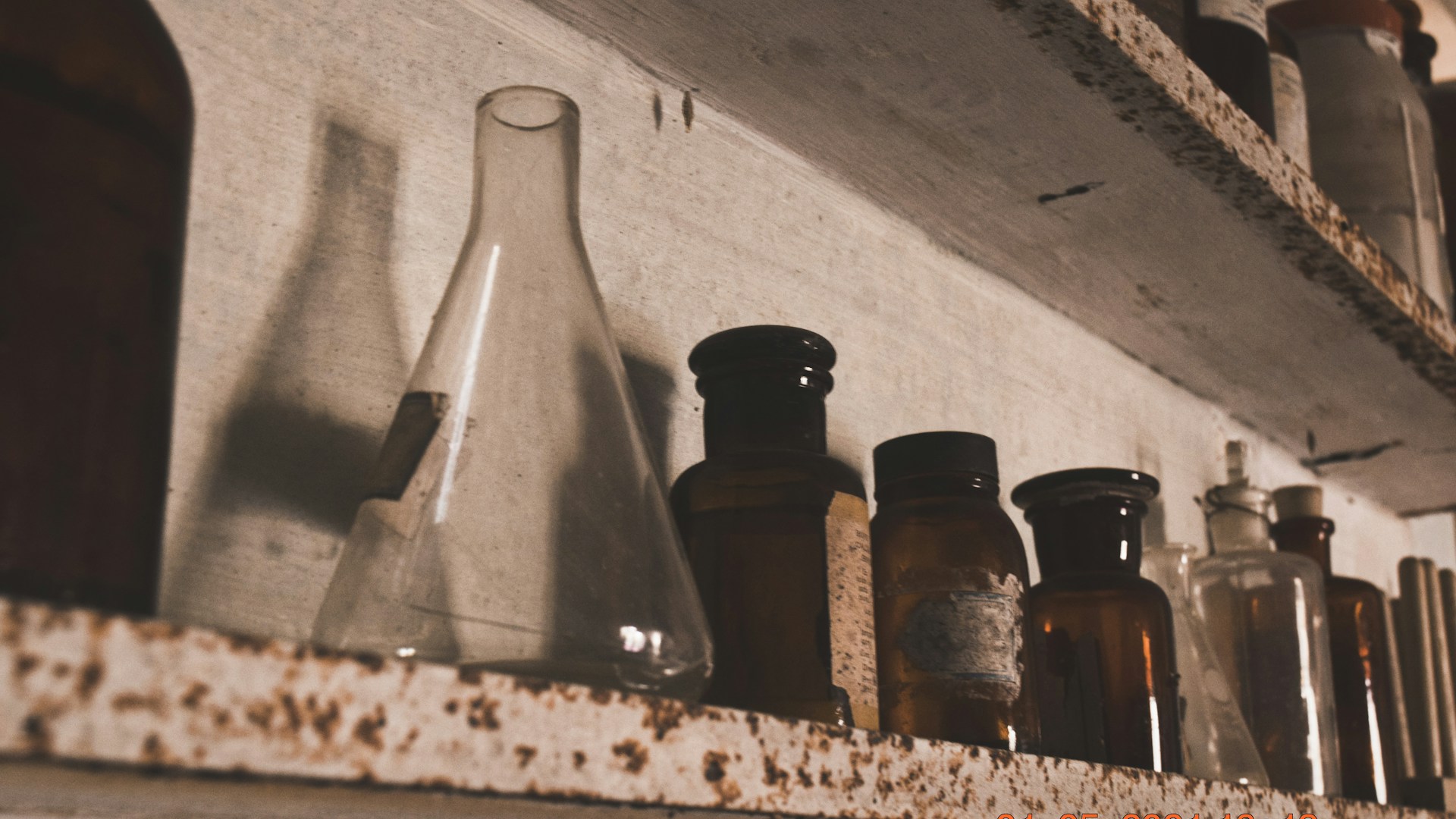Vintage laboratorium med glasflasker på træhyld